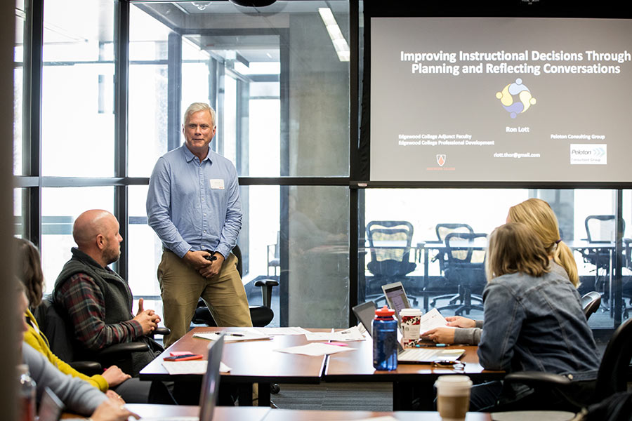 Man speaking in front of group at symposia